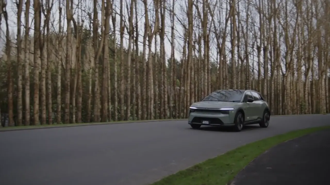 Mitsubishi driving on a tree-lined road
